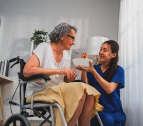 woman feeding senior