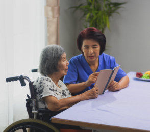 woman and senior holding a book