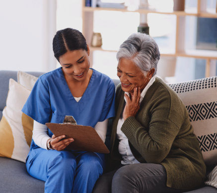 woman showing a paper to senior