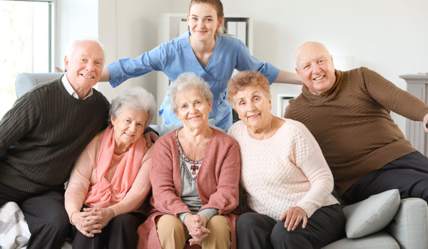 woman standing and group of people sitting