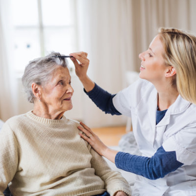 woman comb the hair of senior